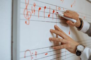 man-writing-music-notes-2022-03-04-06-19-03-utc-705x471